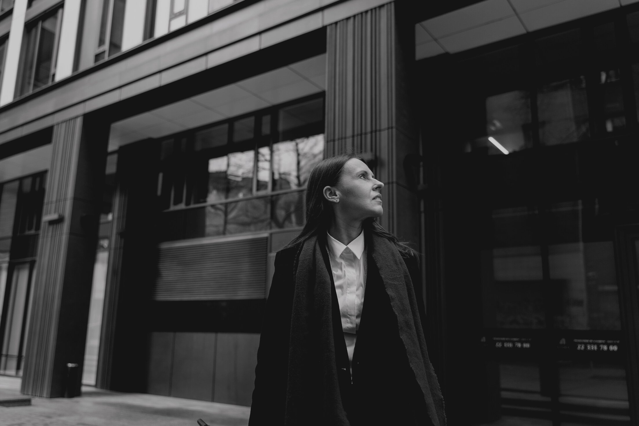 Woman in Blue Coat With Scarf Looking Up 